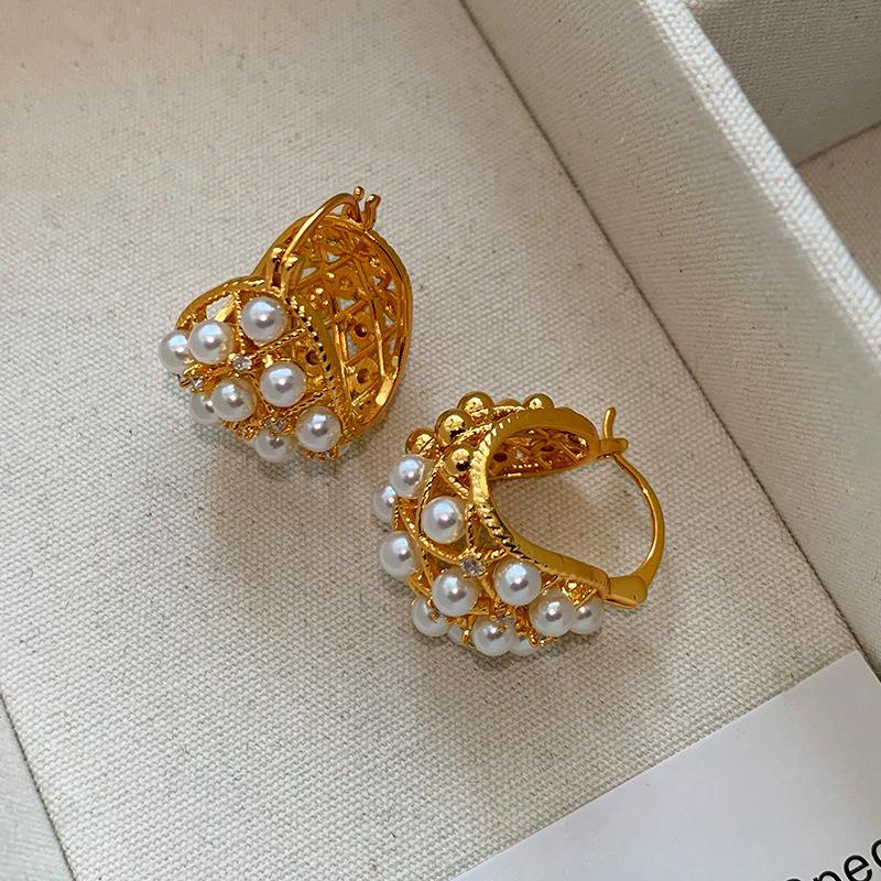 Temperament hollow flower basket pearl earrings women s new popular high-end ear buckle niche design unique earrings
Temperament hollow flower basket pearl earrings women s new popular high-end ear buckle niche design unique earrings