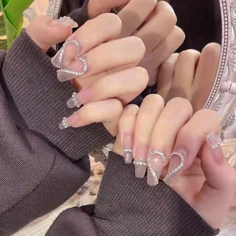 Nude Long Press-On Nails with Heart Rhinestones, Chain, & Glitter Stickers Glue Package
Nude Long Press-On Nails with Heart Rhinestones, Chain, & Glitter Stickers Glue Package