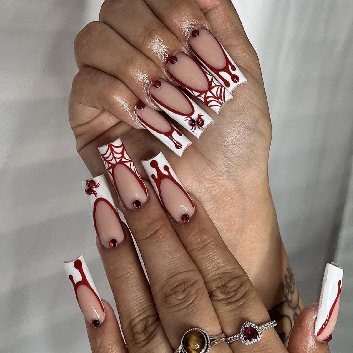 Halloween Blood Drop & Spiderweb Nail Art: Long White French Tip with Red Diamond Spider Accents
Halloween Blood Drop & Spiderweb Nail Art: Long White French Tip with Red Diamond Spider Accents