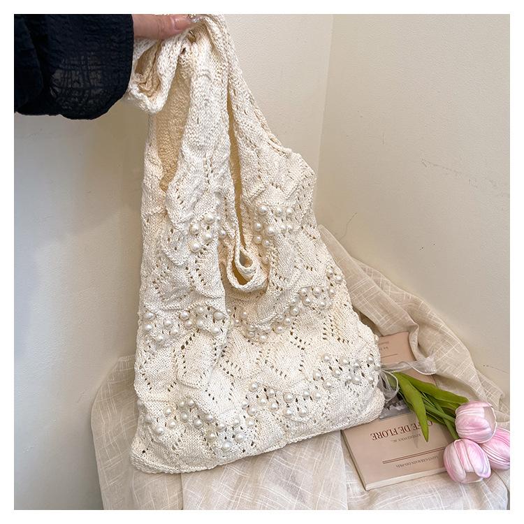2025 новая ретро ленивый стиль вязаная сумка лето новая жемчужная ажурная портативная сумка на плечо универсальная литературная для通勤