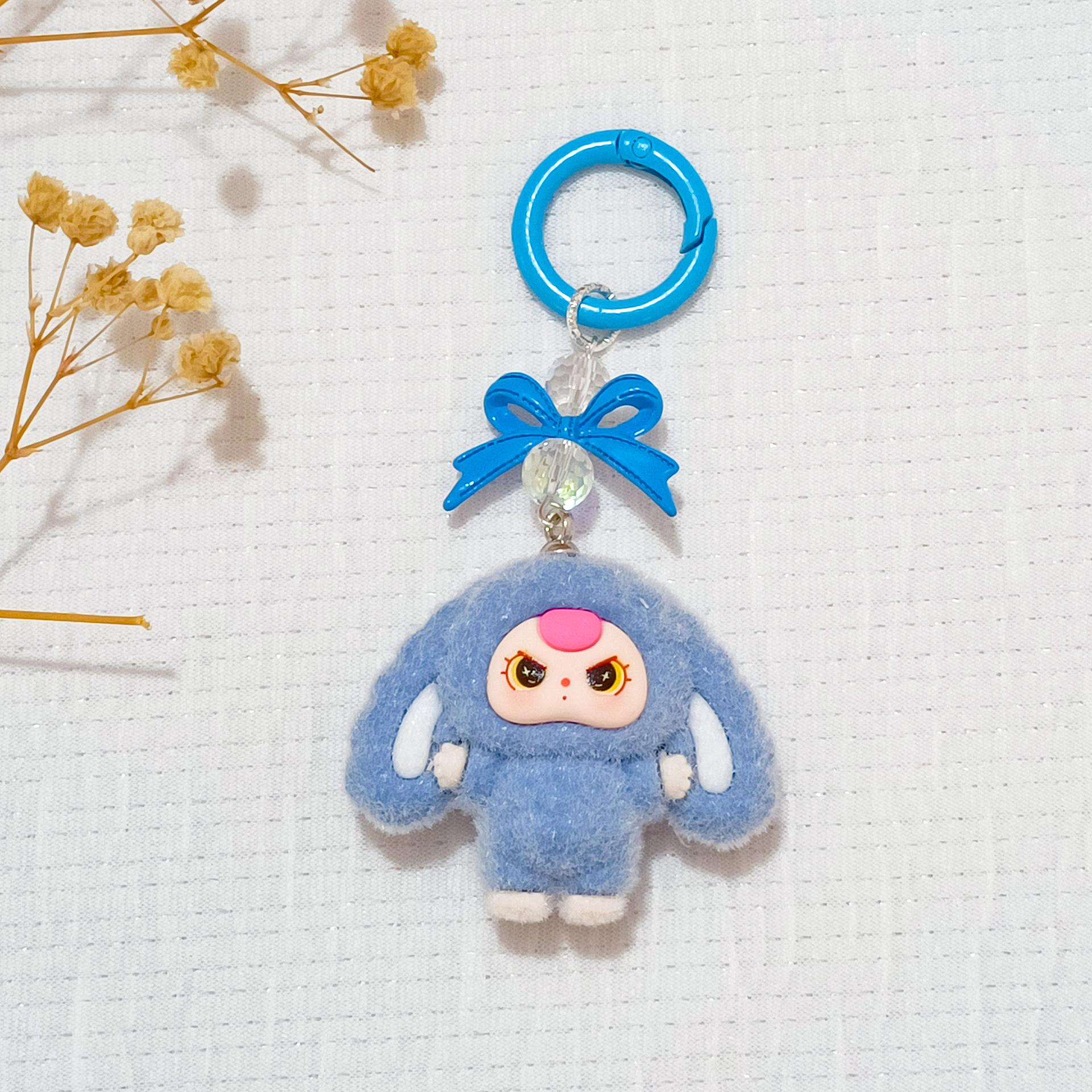 Bowknot Flocked Big-Eared Doll Keychain - 3D Cartoon Figurine for Schoolbags
Bowknot Flocked Big-Eared Doll Keychain - 3D Cartoon Figurine for Schoolbags