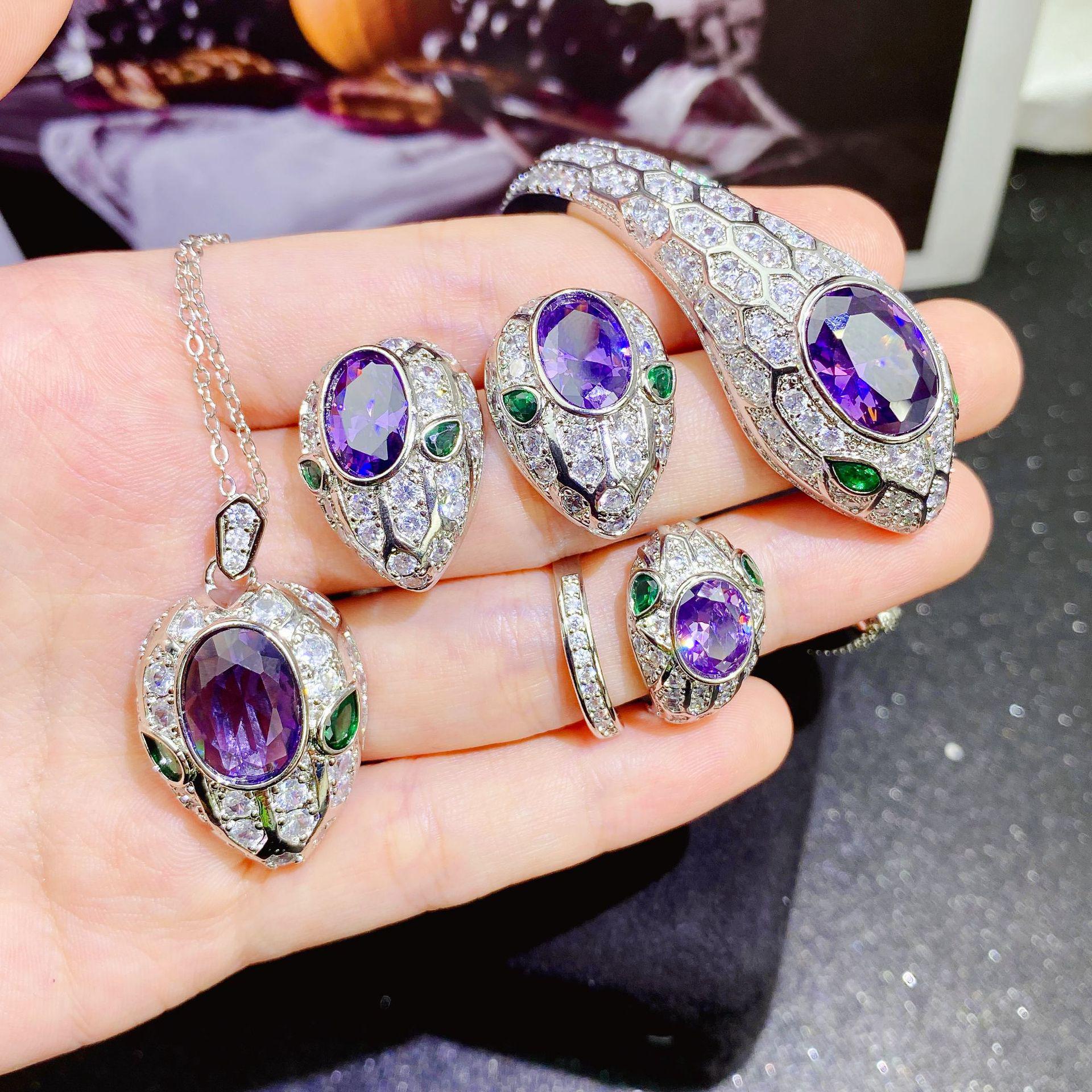 Serpentine Amethyst Jewelry Set: High-End Snake Bracelet, Pendant, Open Ring, Purple Diamond Earrings.
Serpentine Amethyst Jewelry Set: High-End Snake Bracelet, Pendant, Open Ring, Purple Diamond Earrings.