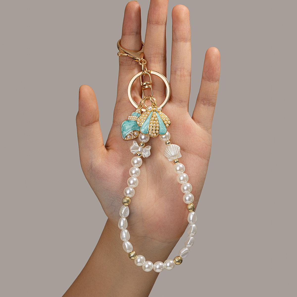 Light Luxury Ocean Style Imitation Pearl Beaded Keychain Mint Green Diamond-Inlaid Conch Shell Pendant Phone Strap
Light Luxury Ocean Style Imitation Pearl Beaded Keychain Mint Green Diamond-Inlaid Conch Shell Pendant Phone Strap