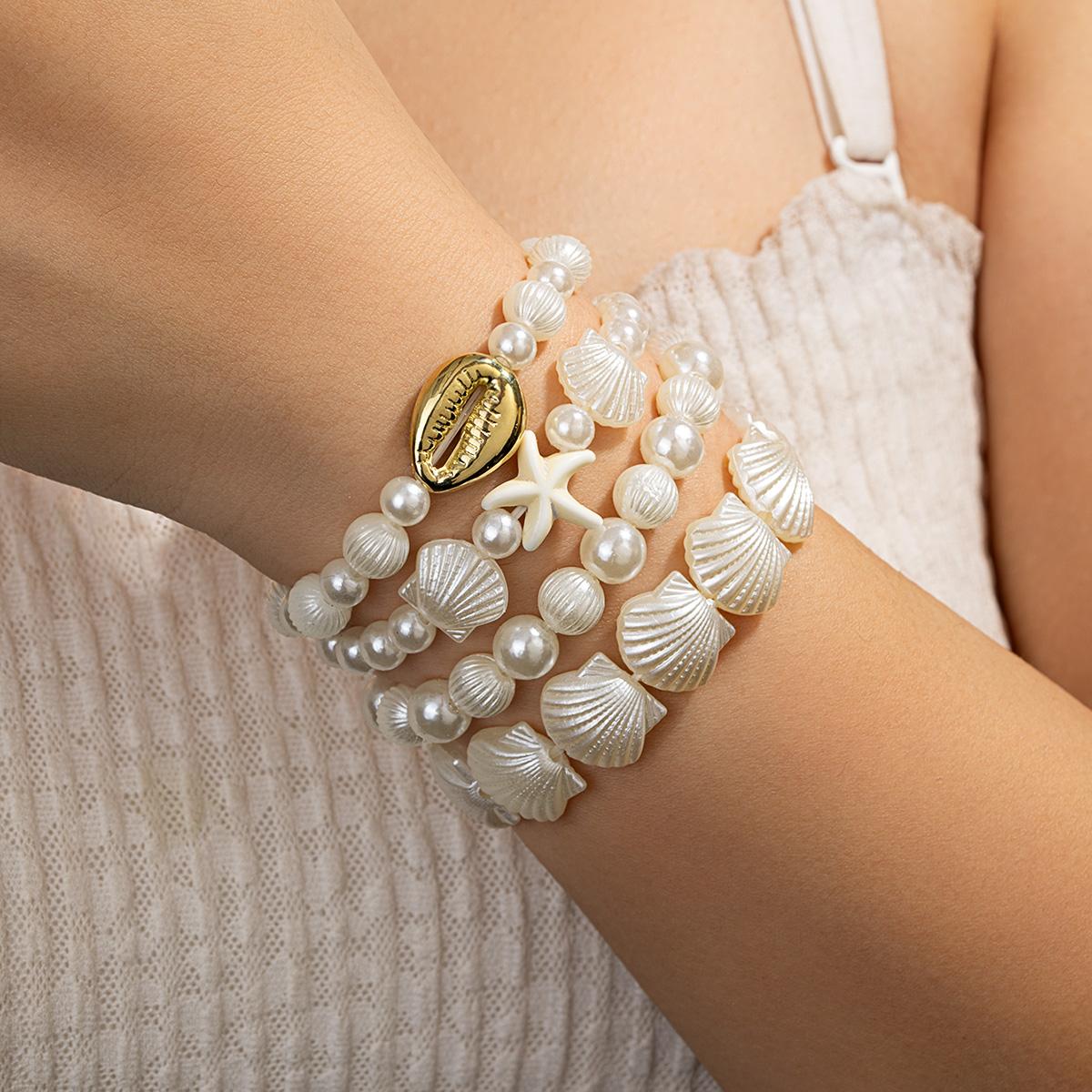 Ocean-style four-layer bracelet with shells and pearls, vintage golden shell coins and starfish beaded strands
Ocean-style four-layer bracelet with shells and pearls, vintage golden shell coins and starfish beaded strands