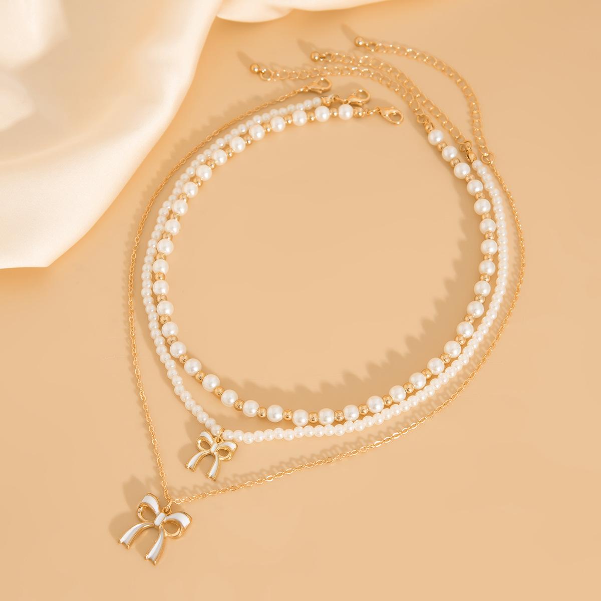 Аксессуары Многослойные банты Ожерелья из бисера Популярные универсальные нишевые цепочки на ключицу Модные ожерелья
Аксессуары Многослойные банты Ожерелья из бисера Популярные универсальные нишевые цепочки на ключицу Модные ожерелья