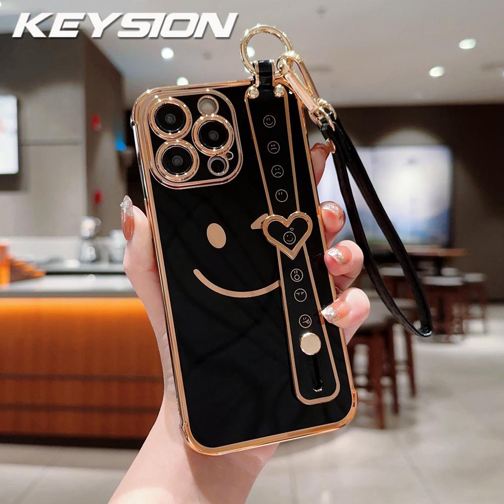 KEYSION Wrist Strap Smiley Face Phone Case for iPhone 13 14 15 16 17 Pro Max 17 Air 16e 16 Plus Plating Silicone Lanyard Shockproof Cover for iPhone 13 Pro Max чорний
KEYSION Wrist Strap Smiley Face Phone Case for iPhone 13 14 15 16 17 Pro Max 17 Air 16e 16 Plus Plating Silicone Lanyard Shockproof Cover for iPhone 13 Pro Max чорний