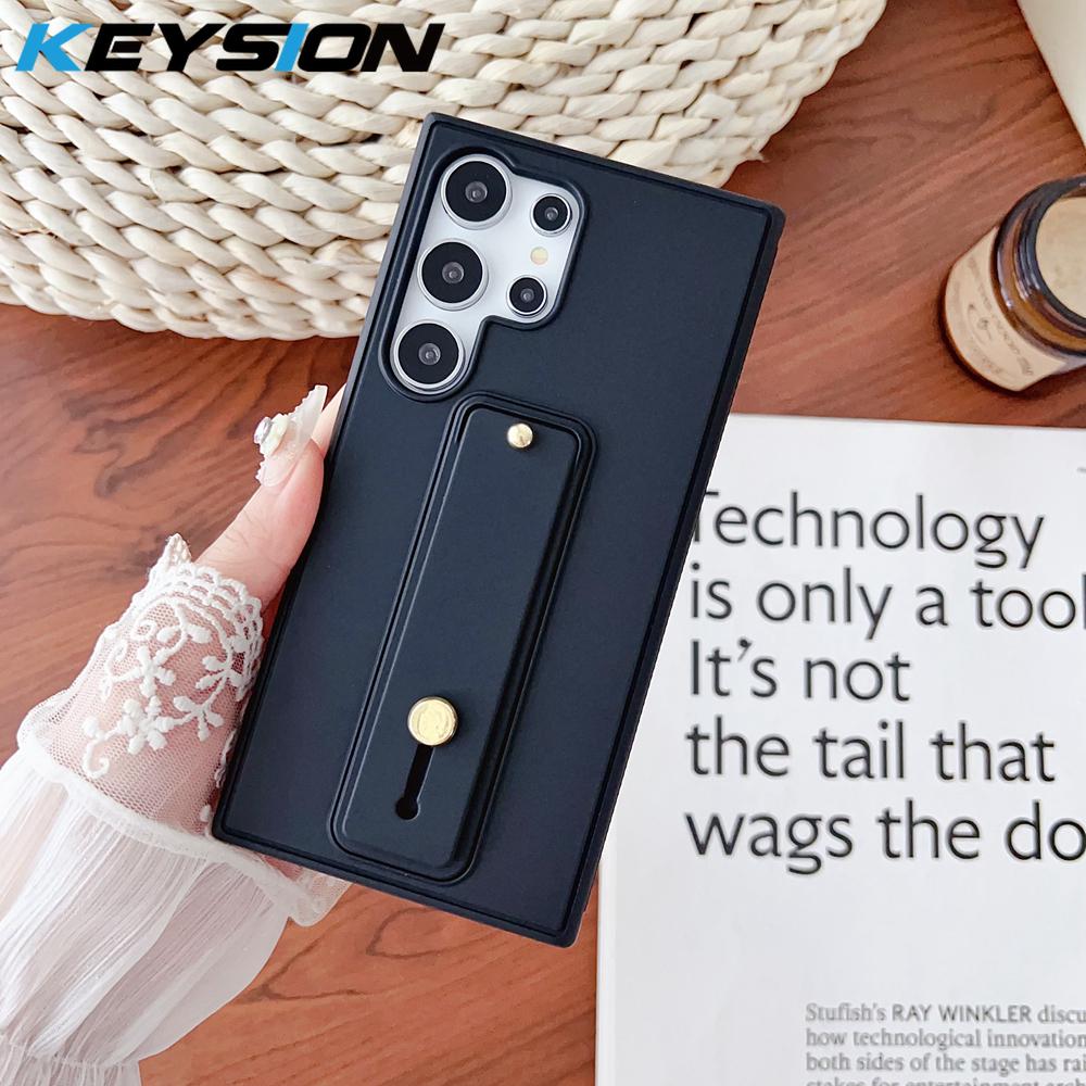KEYSION Wrist Strap Phone Case for Samsung Galaxy S26 Ultra 5G S26+ Plus Wristband Kickstand Matte TPU+PC Shockproof Back Cover for Galaxy S26 чёрный
KEYSION Wrist Strap Phone Case for Samsung Galaxy S26 Ultra 5G S26+ Plus Wristband Kickstand Matte TPU+PC Shockproof Back Cover for Galaxy S26 чёрный
