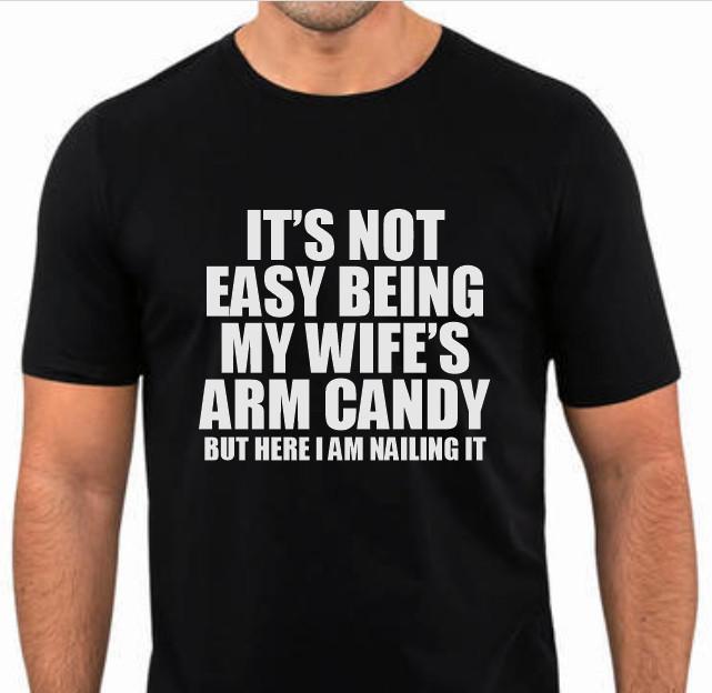 It s not easy being my wifes arm candy Funny T shirt tee 2XL
It s not easy being my wifes arm candy Funny T shirt tee 2XL