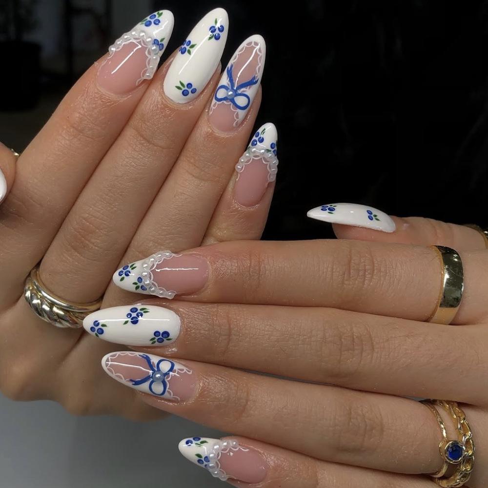 Blueberry Print Almond-Shaped Wearable Nails with White French Tips, Lace Trim, and Pearl Bow Accents.
Blueberry Print Almond-Shaped Wearable Nails with White French Tips, Lace Trim, and Pearl Bow Accents.