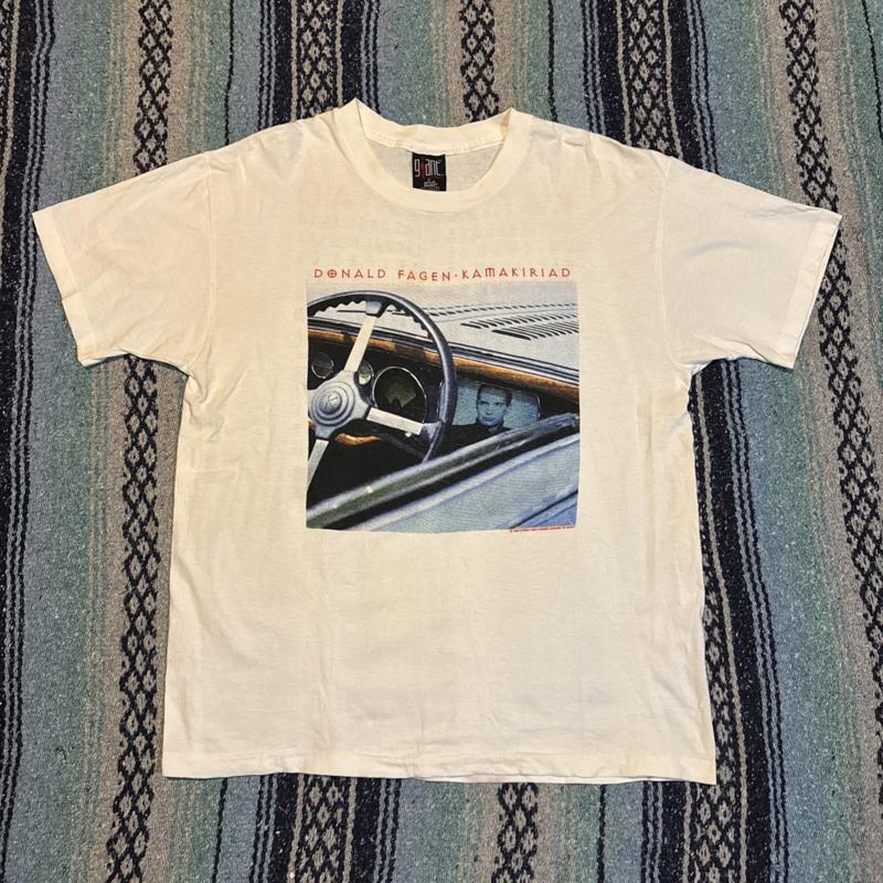 Vintage Donald Fagen Kamakiriad Giant T-Shirt XL Steely Dan Band Concert Tee 5XL різнокольоровий
Vintage Donald Fagen Kamakiriad Giant T-Shirt XL Steely Dan Band Concert Tee 5XL різнокольоровий