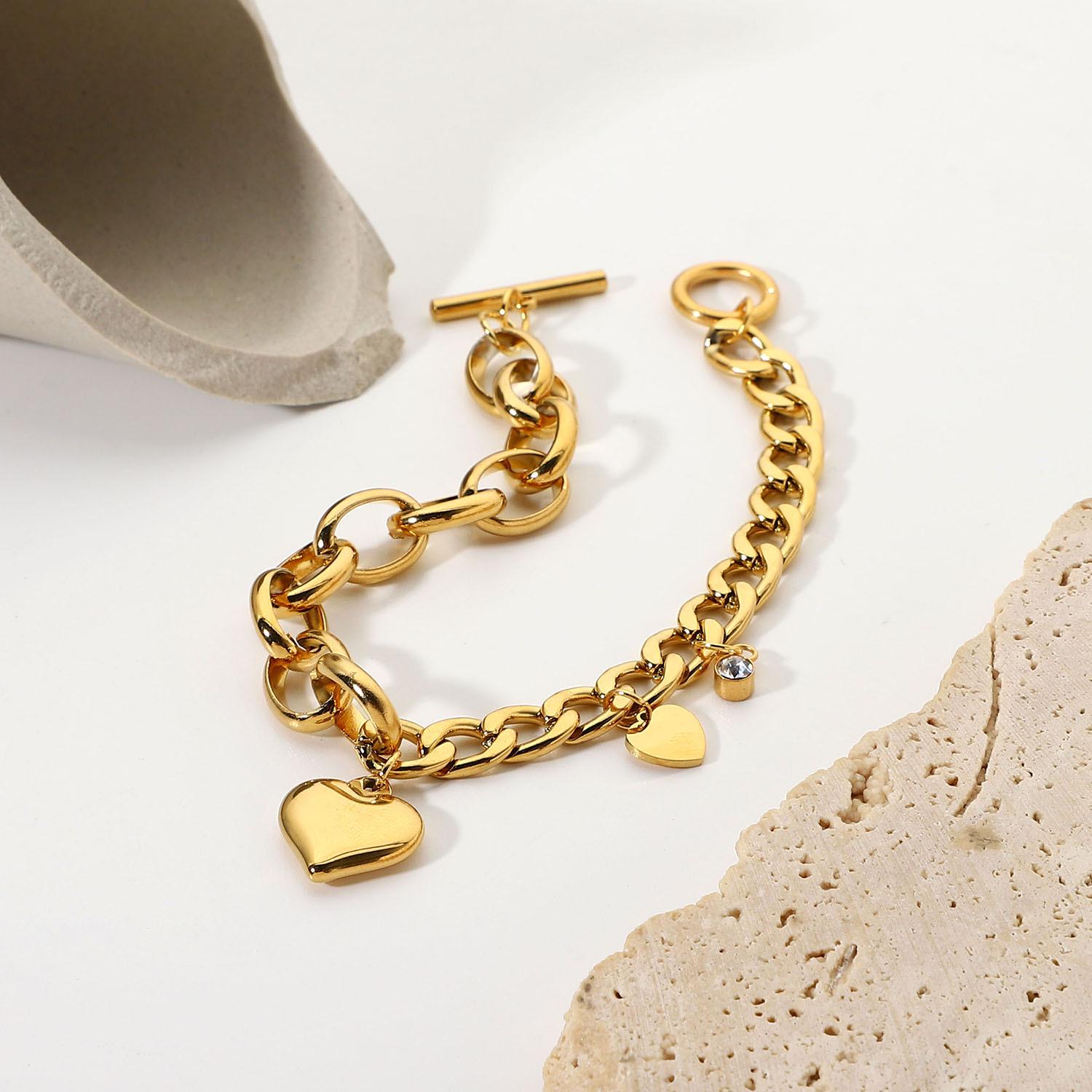 Two-Tone Heart & Zircon Pendant Cuban Chain Bracelet, Oval Links, OT Clasp, 18K Gold Plated Stainless Steel.
Two-Tone Heart & Zircon Pendant Cuban Chain Bracelet, Oval Links, OT Clasp, 18K Gold Plated Stainless Steel.