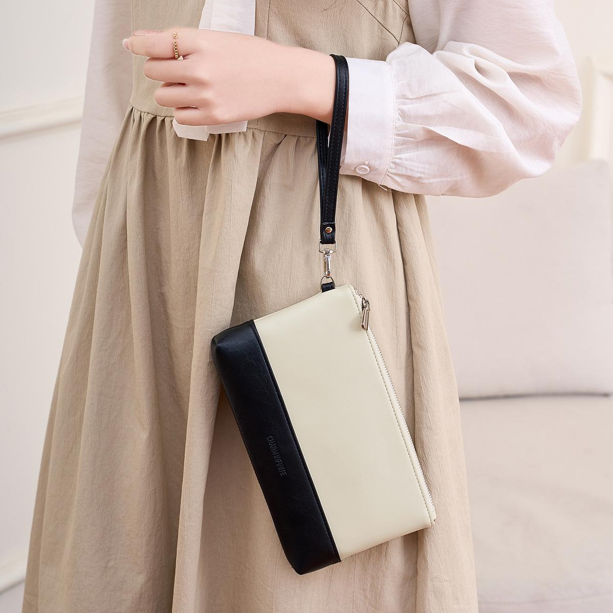 New multi-functional women s clutch bag splicing contrasting colors fashionable handbag simple large-capacity mobile phone wallet peacock синього кольору 
New multi-functional women s clutch bag splicing contrasting colors fashionable handbag simple large-capacity mobile phone wallet peacock синього кольору