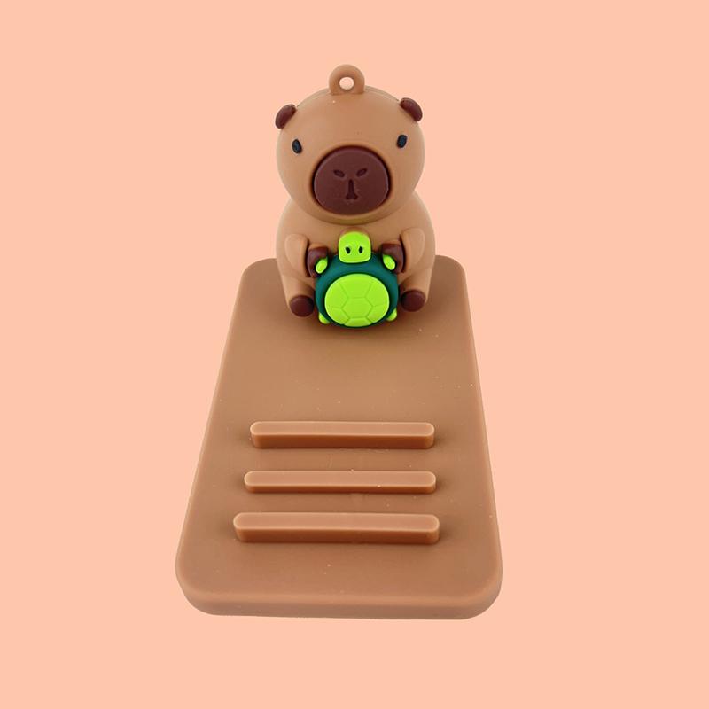 Креативная подставка для мобильного телефона и планшета в виде капибары, мультяшные настольные украшения, портативная ленивая подставка для телефона, аксессуары
Креативная подставка для мобильного телефона и планшета в виде капибары, мультяшные настольные украшения, портативная ленивая подставка для телефона, аксессуары