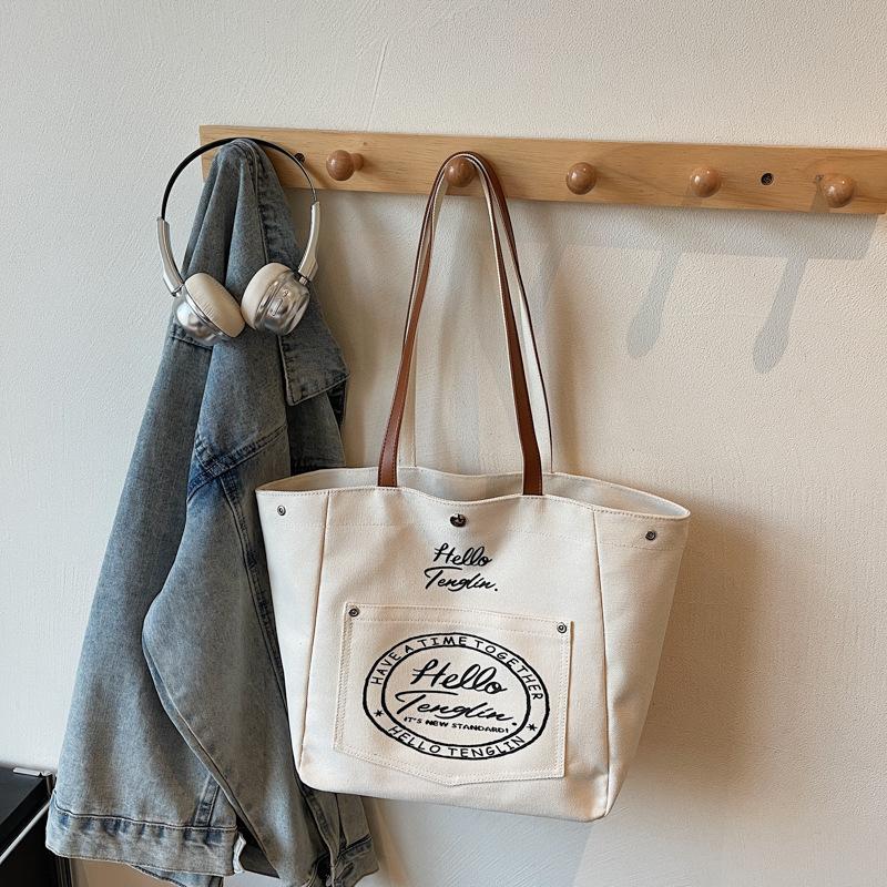 Fashi Korean Style Large Capacity Canvas Top Handle Bag Texture Simple Shoulder Bag for Women with Letter Print Storage Bags
Fashi Korean Style Large Capacity Canvas Top Handle Bag Texture Simple Shoulder Bag for Women with Letter Print Storage Bags