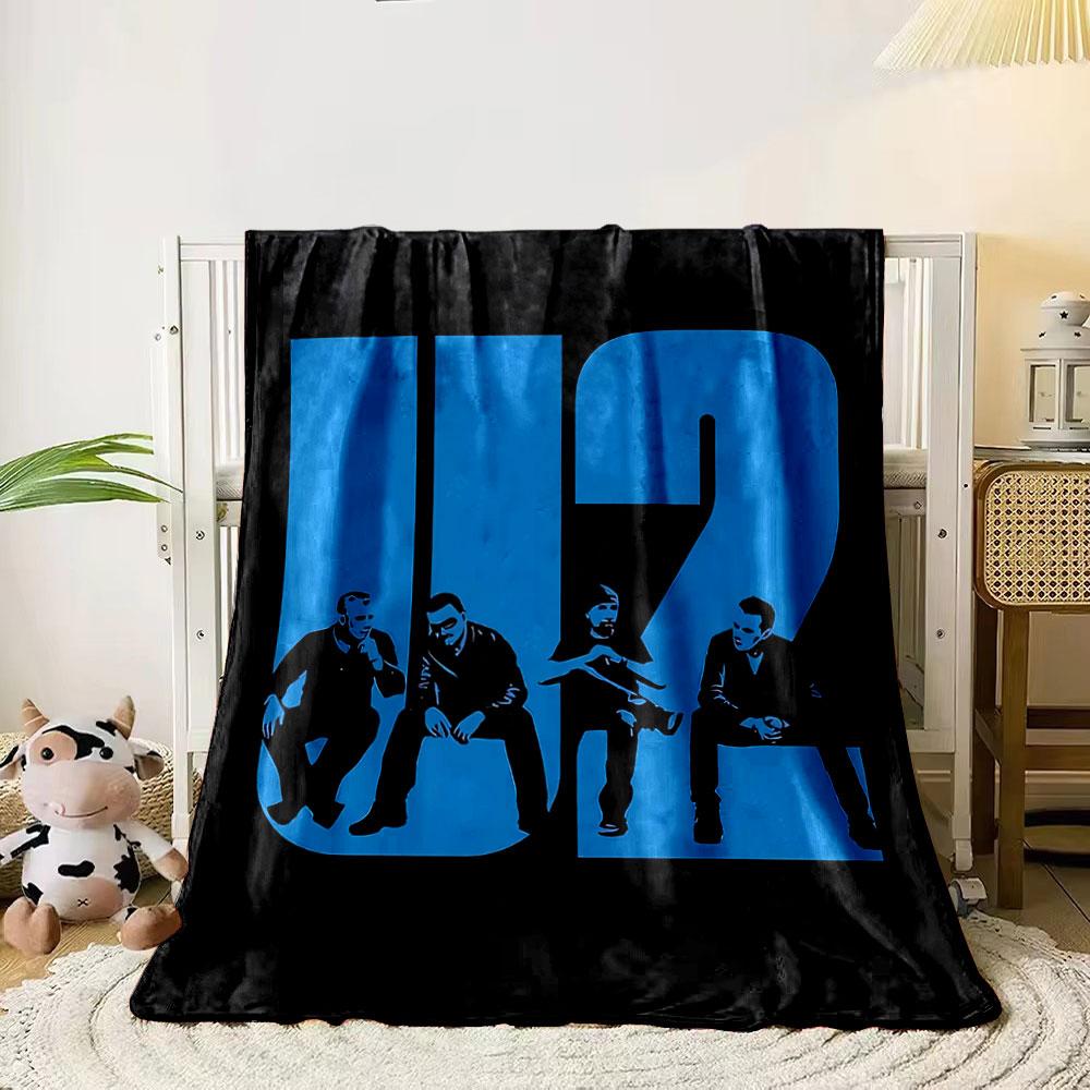 Bold blue U2 text integrates silhouettes of seated figures in black. for all seasons blanket lunch break throw gift 80cm x 120cm
Bold blue U2 text integrates silhouettes of seated figures in black. for all seasons blanket lunch break throw gift 80cm x 120cm