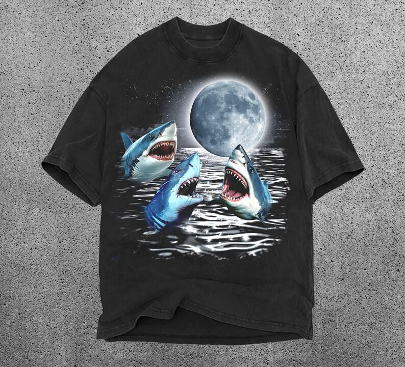 Three Shark Moon Shirt Shark Shirt Vintage Shark T-shirt, Ocean Lover Gift Shark Gift Unisex Graphic T-shirt Shark Weird Core 4XL
Three Shark Moon Shirt Shark Shirt Vintage Shark T-shirt, Ocean Lover Gift Shark Gift Unisex Graphic T-shirt Shark Weird Core 4XL