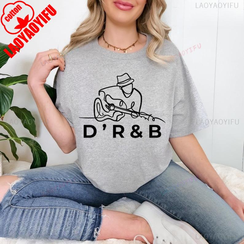 Souvenir Dangelo Shirts DRB Line Art Music Minimal Guitarist Soulful Inspired Graphic for Music Lovers and Artists T Shirt 4XL
Souvenir Dangelo Shirts DRB Line Art Music Minimal Guitarist Soulful Inspired Graphic for Music Lovers and Artists T Shirt 4XL