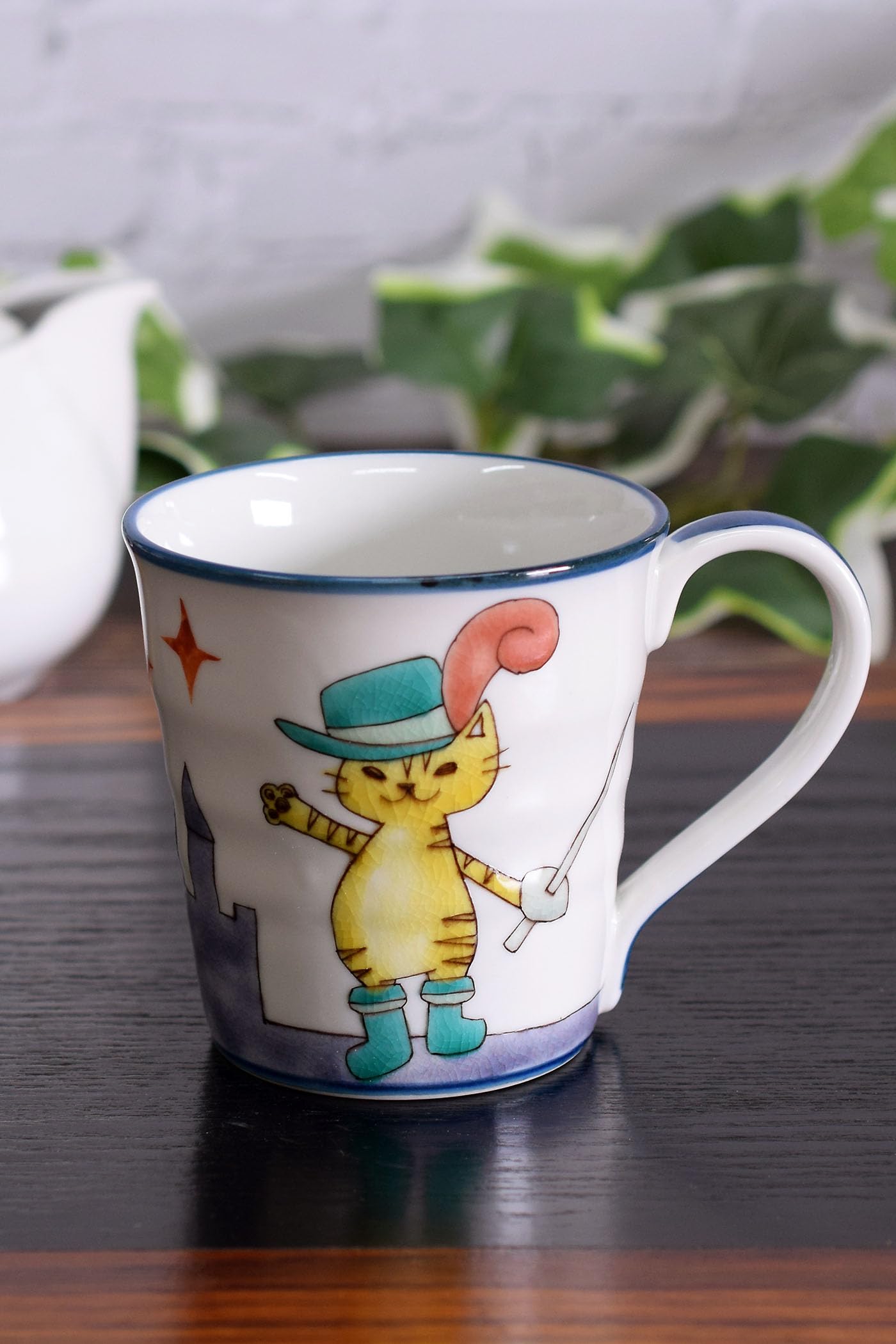 Waza no Kura Stylish Kutani Ware Mug with a Puss in Boots Design. Made in Japan. A perfect gift for birthdays, 60th, 70th, 77th, and 88th birthdays.
Waza no Kura Stylish Kutani Ware Mug with a Puss in Boots Design. Made in Japan. A perfect gift for birthdays, 60th, 70th, 77th, and 88th birthdays.
