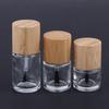 Cylindrical Glass Nail Oil Bottles with Solid Wood and Bamboo Caps – Available In 5ml, 10ml, and 15ml Capacities