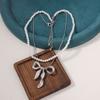 Hot-selling light luxury imitation pearl fashion one more wear personalized metal bow pendant women's necklace