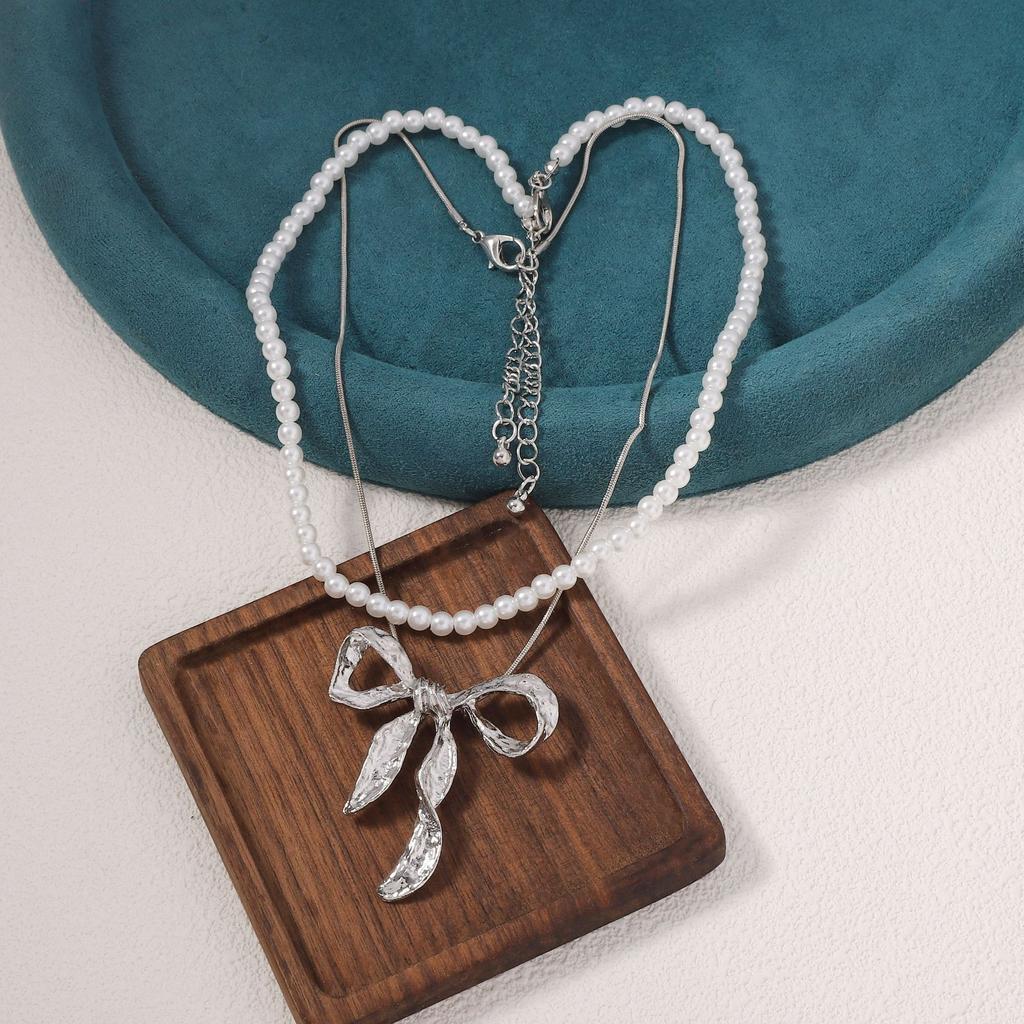Hot-selling light luxury imitation pearl fashion one more wear personalized metal bow pendant women's necklace