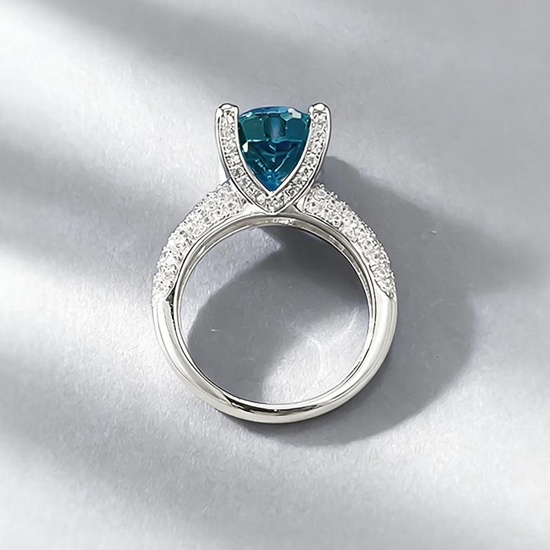 Xiancan Jewelry S925 Silver Oval Paraiba Ice Flower Cut Ring with High Carbon Diamond.