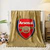 A red shield logo with a cannon design, surrounded by a gold dotted pattern. for all seasons blanket lunch break throw gift