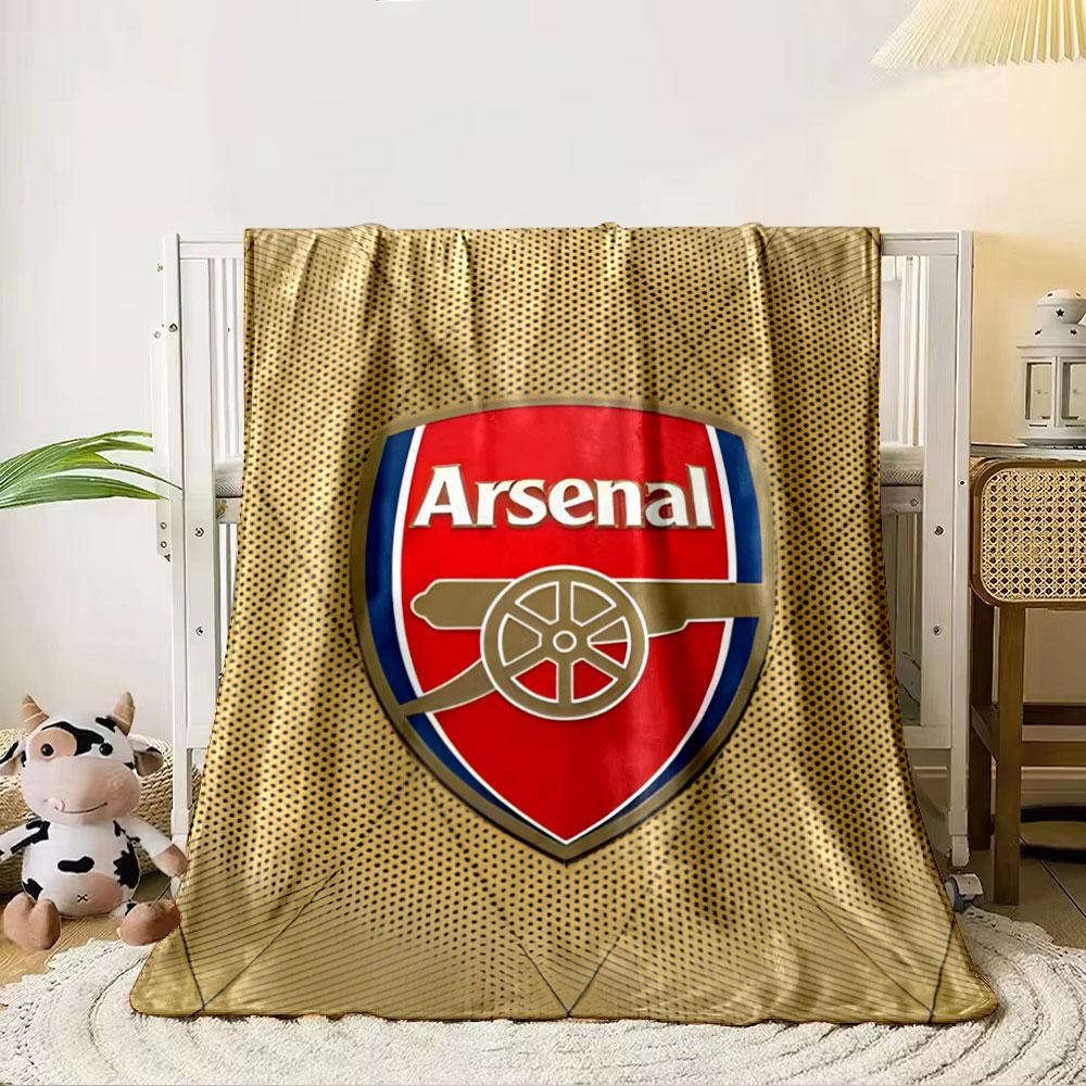 A red shield logo with a cannon design, surrounded by a gold dotted pattern. for all seasons blanket lunch break throw gift