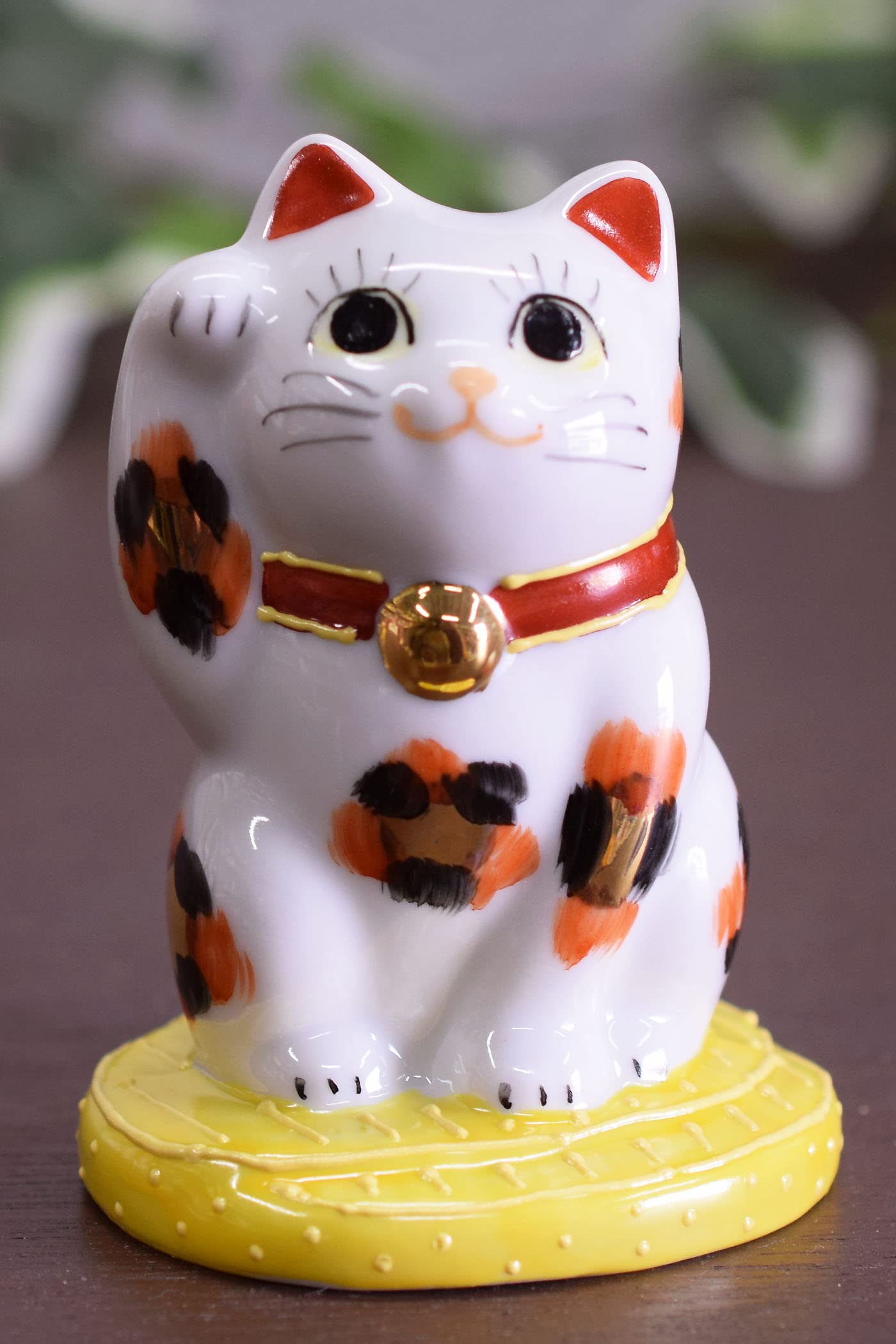 

Stylish Kutani Ware Figurine by Waza no Perfect as a gift for housewarmings or store Oval-Riding Maneki-Neko (Lucky Cat) Kura. openings.