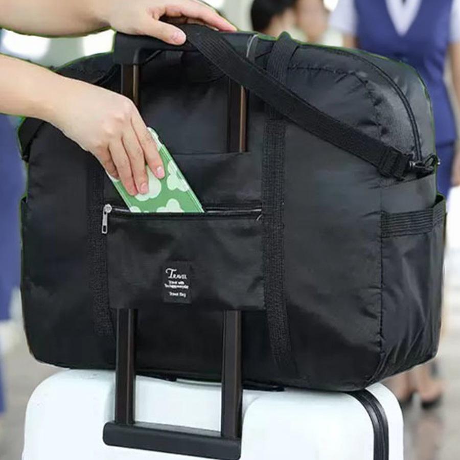 Compact travel bag: suitcase-compatible, hand-held, features an external pocket, handle slip-over design, with matching accessory bag.
