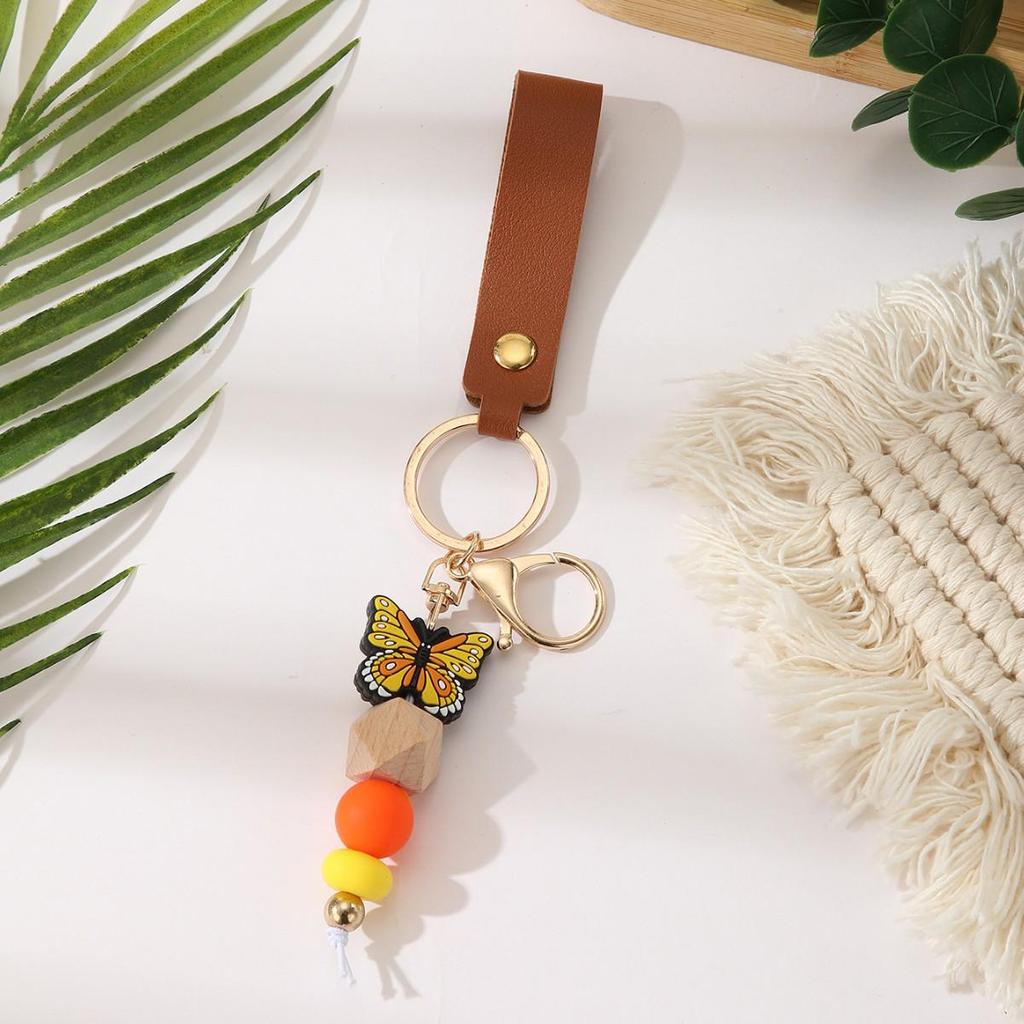 European & American Sweet Butterfly Daisy Silicone Beaded Keychain with Leather Bow Pendant