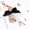 Korean-Style Handmade Rhinestone Perfume Bottle Keychain with Bow and Pearl Charm