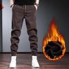 Men's Black Corduroy Plus Velvet Thickened Tapered Casual Pants for Autumn and Winter.