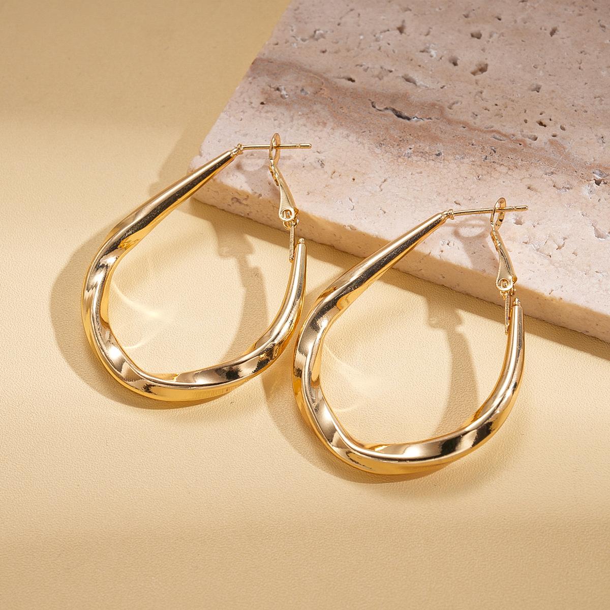 Simple geometric twist, water drop-shaped glossy silver needle earrings, environmentally friendly niche earrings