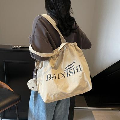 Veelzijdige nylon stoffen tas met trekkoord en grote capaciteit, nieuwe canvas tas, tote bag met letters, schouder boodschappentas.