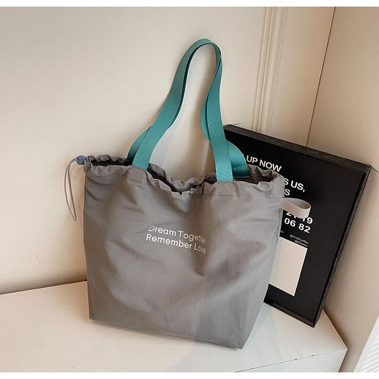 

New women s bag style simple design single shoulder canvas large capacity letter tote bag fashion сірий колір