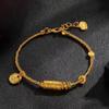 Lucky Goddess Gold-Color Ethnic Bracelet with Engraved Barrel Beads and Tibetan Rope.