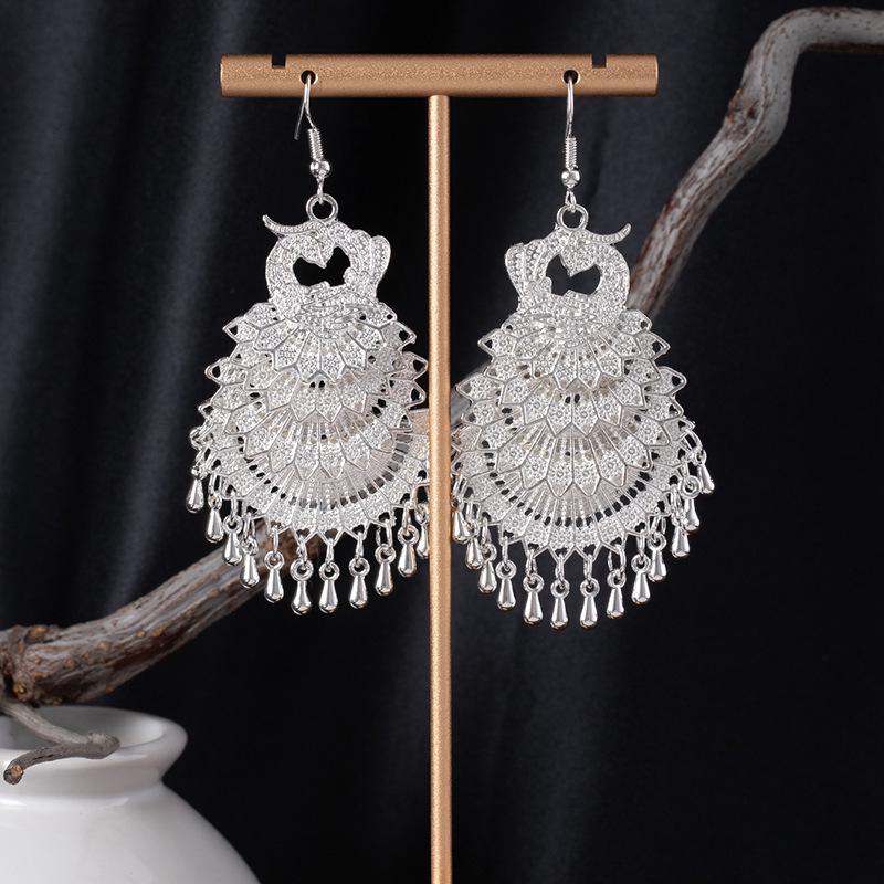 Bohemian Ethnic Miao Silver Tassel Earrings with Butterfly, Peacock, and Flower Design for Women – Long Dangle Jewelry for Travel Photos.