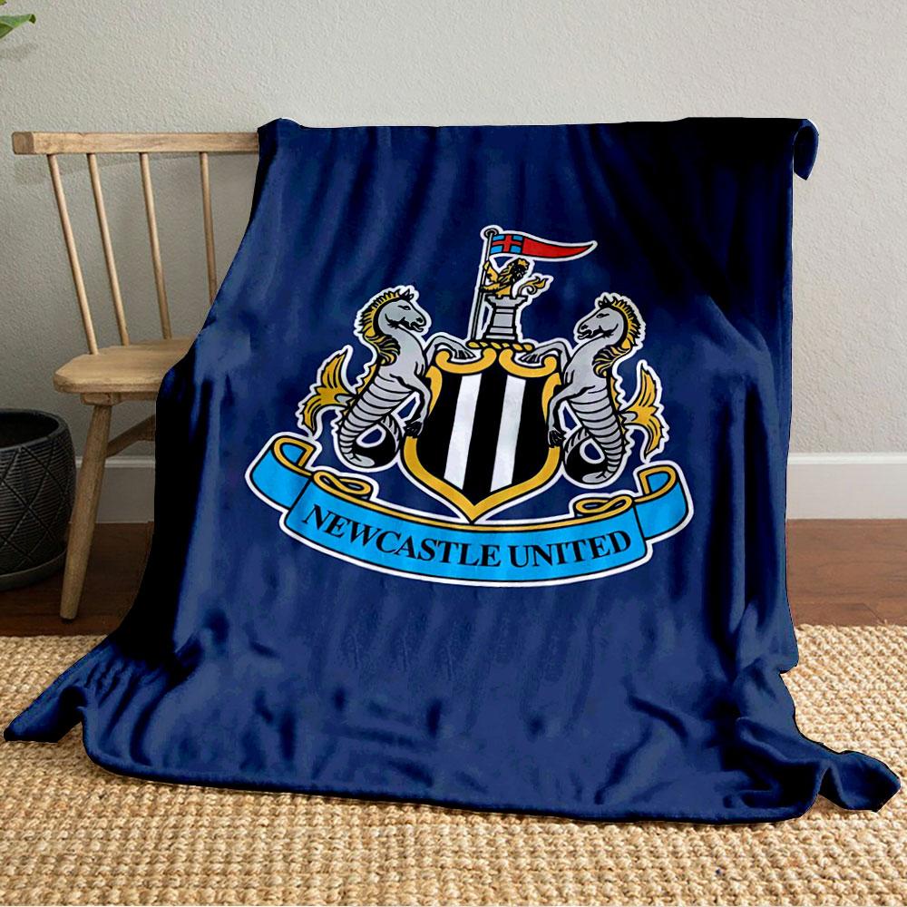 A shield with black and white stripes, flanked by seahorses, and a banner. for all seasons blanket lunch break throw gift