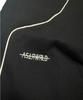 Aseuteleuwoldeu Symbol Logo Two-Tuck Cotton Track Pants (Black)