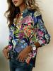 Women's shirt, featuring a vibrant tropical floral design, with long sleeves and button closure, is perfect for beach vacations and casual outings.