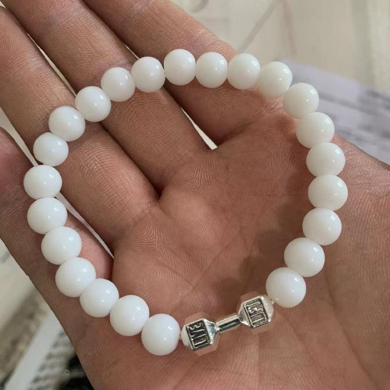 

Матовый черный браслет из вулканического камня и сплава в виде гантели