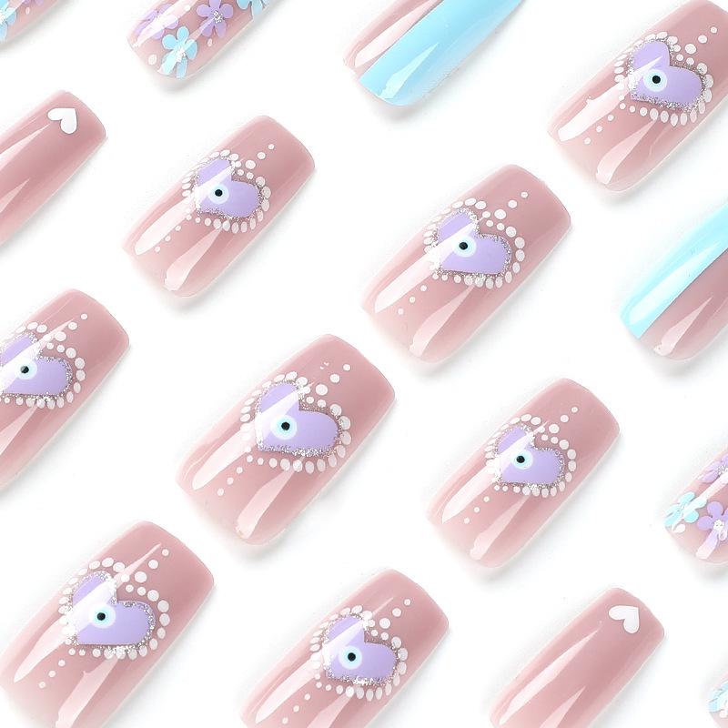 White Flame & Polka Dot Press-On Nails with Gold Glitter, Heart Designs, and Light Blue Flowers.