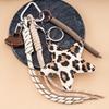 MIU Series Leopard Print PU Leather Pentagram Bag Charm with Bow and Handmade Woven Keyring