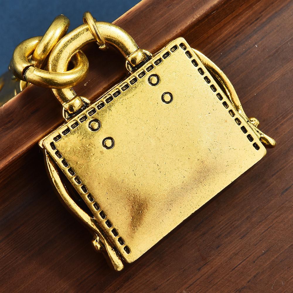 Metallischer Schlüsselanhänger Taschenanhänger Mit Graviertem Buchmuster Für Modeaccessoires