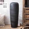 Jingdezhen Black Coarse Pottery Floor Vase: Modern Minimalist Japanese Decor for Hotel, Homestay, or Living Room.