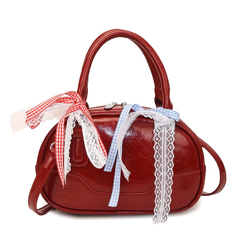 Frühling 2025 neu Ou Ruofeng Koreanische Version von einfacher tragbarer Boston-Tasche Nische lässig vielseitige Umhängetasche Tasche Damen