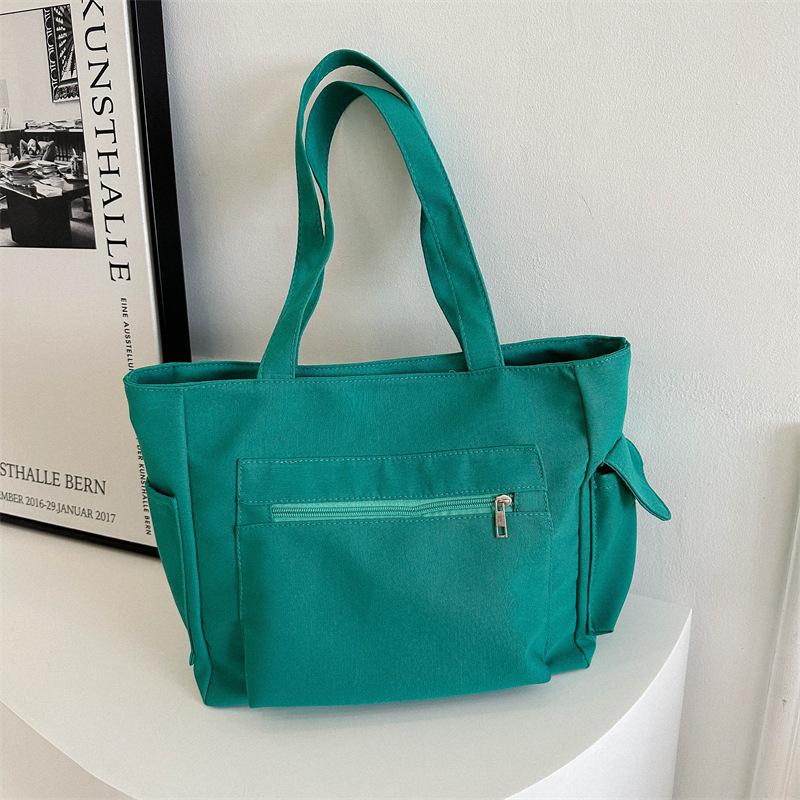 

Korean version niche design simple canvas solid color bag women s bag 2024 winter new large-capacity shoulder armpit bag зелений
