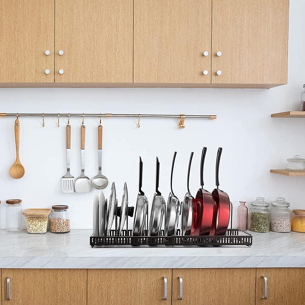 Extendable frying pan rack with 7 compartments, perfect for storing pans, pots, lids, and cutting boards.