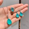 Zhuang Shengsheng Colored Gemstone Jewelry Set: Simulated Paraiba Pendant, Necklace, Ring, and Earrings.